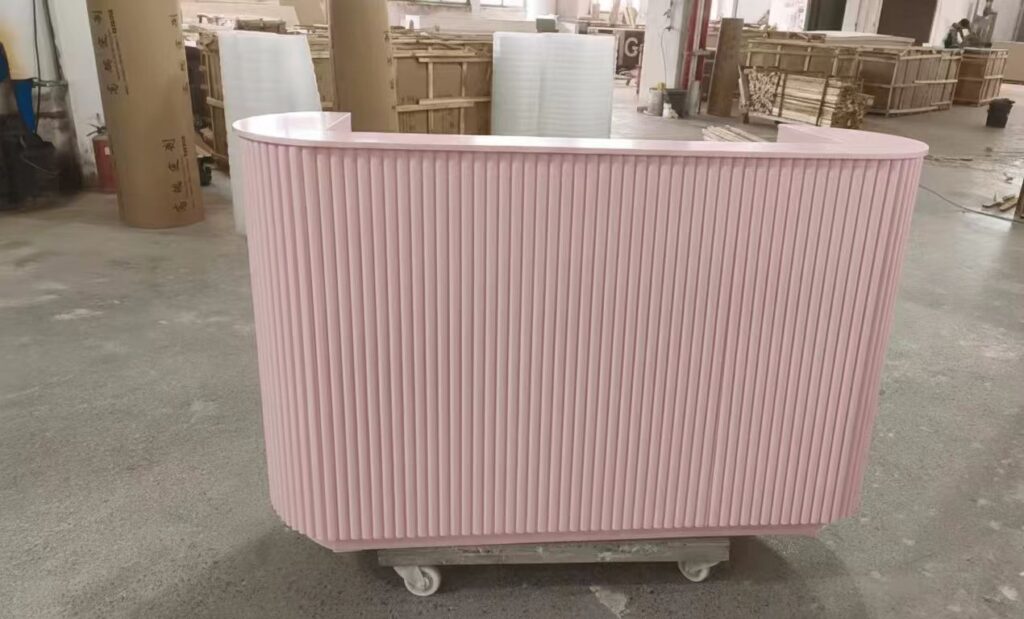 Modern curved reception desk design featuring grooved flexible MDF facing